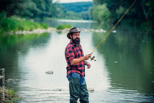 Male hobby. Ready for fishing. Relax in natural environment. Trout bait. Bearded elegant man. Man relaxing nature background. Strategy. Hobby sport activity. Activity and hobby. Catching and fishing.