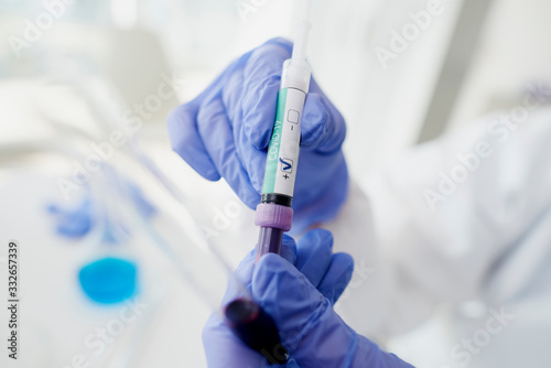Coronavirus test in hands in protective gloves