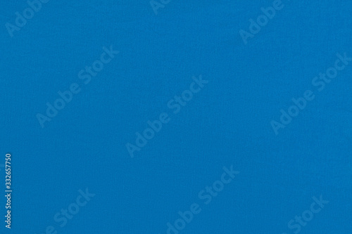 Blue homogeneous background with a textured surface, fabric.