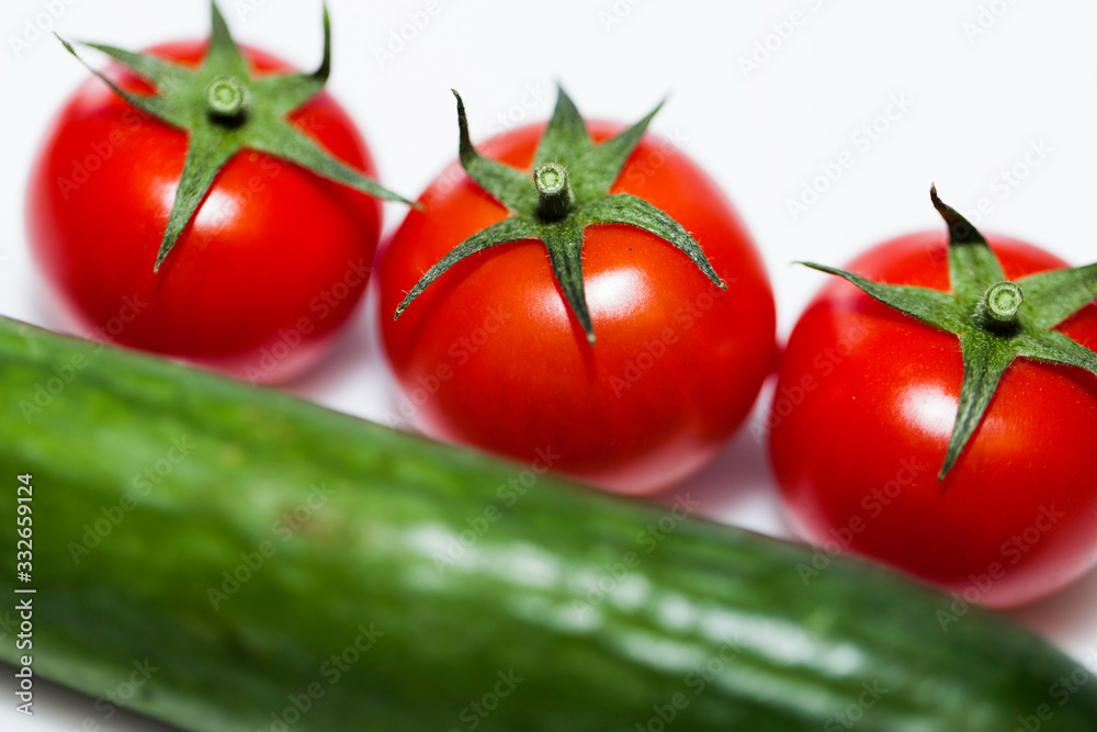 tomatoes and cucumbers on white background tomatoes and cucumbers on white background