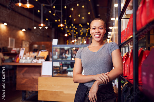 Portrait Of Female Coffee Shop Owner Standing By Counter photo