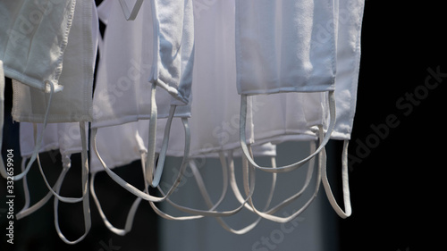 White medical face masks hung for drying in Thailand.
