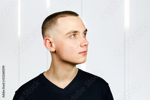 Portrait of young guy with caesar hair cut, Side view.