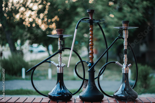 Stylish wooden hookah in the evening on a summer terrace in a cafe