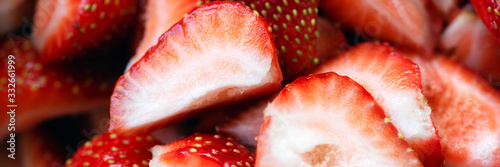 Strawberries are fresh, juicy, close-up sliced. Bright red background.