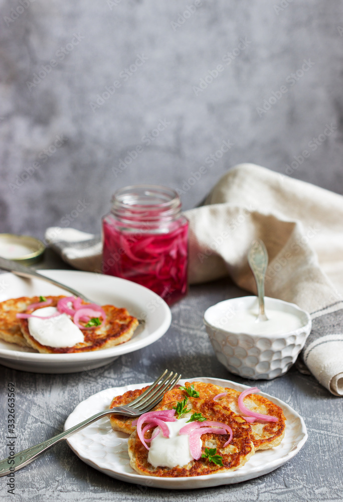 Breakfast made from traditional boxty fritters or latkes served with pickled onions and sour cream. Breakfast made from traditional boxty fritters or latkes served with pickled onions and sour cream.