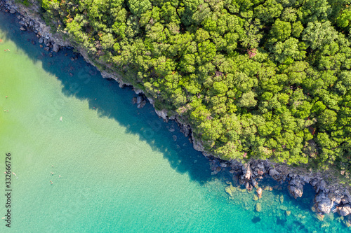 Aerial Drone top down photo of shallow sea and forest in the island of Ischia, Italy