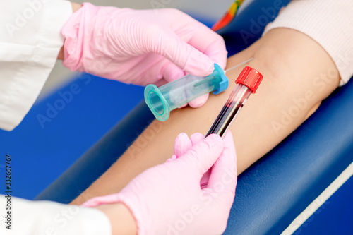 Nurse taking blood sample.