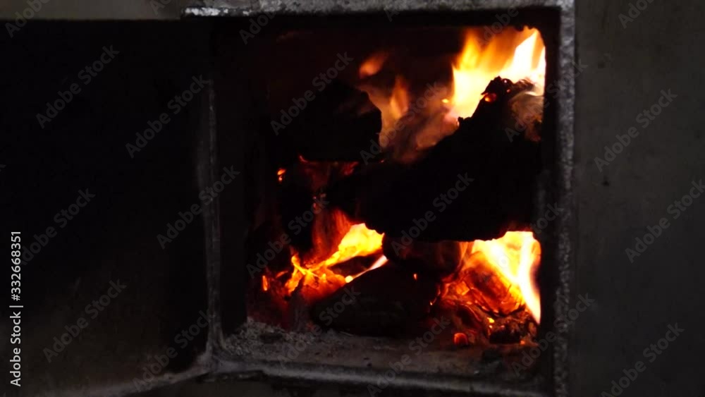 Fire in the stove. The old stove. Village stove. The flame of fire in the furnace. Burning firewood. Red fire. Fire in the stove. The old stove. Village stove. The flame of fire in the furnace. Burning firewood. Red fire.
