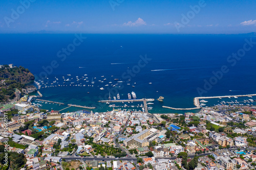 Aerial Drone photo of the beautiful island of ischia with blue sea and skies with hundreds of boats in Ischia, Italy