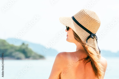 Portrait young woman wearing a straw hat on beach