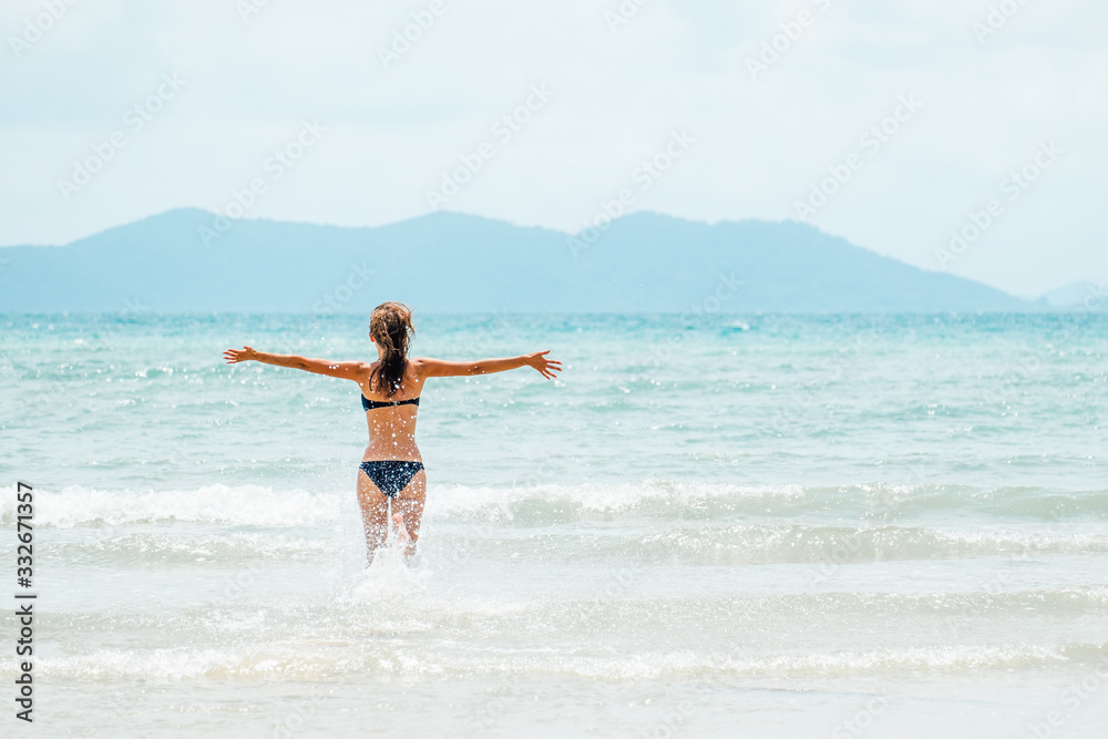 Happy carefree woman wearing bikini having fun on summer vacation