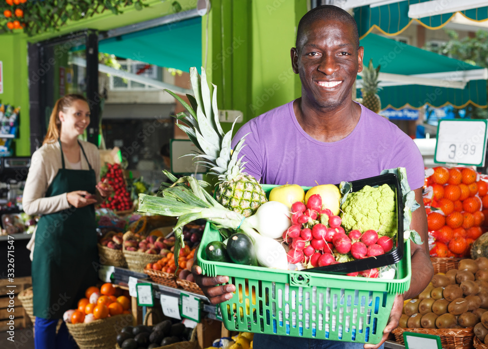 Man with basket in fruit market