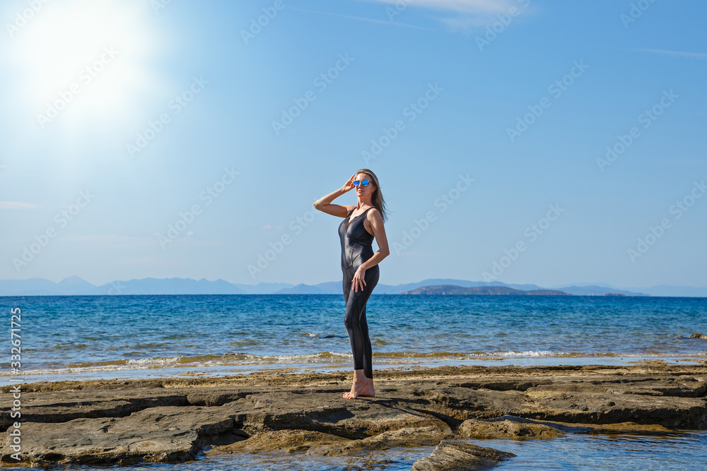 Young beautiful woman in a jumpsuit doing sports