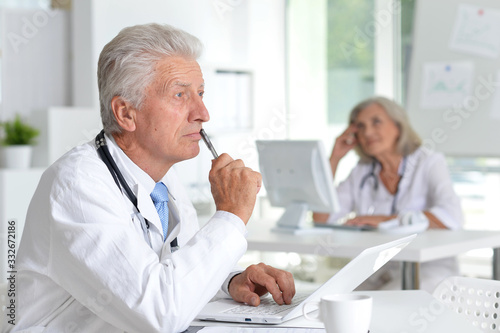 Portrait of male doctor working at desk