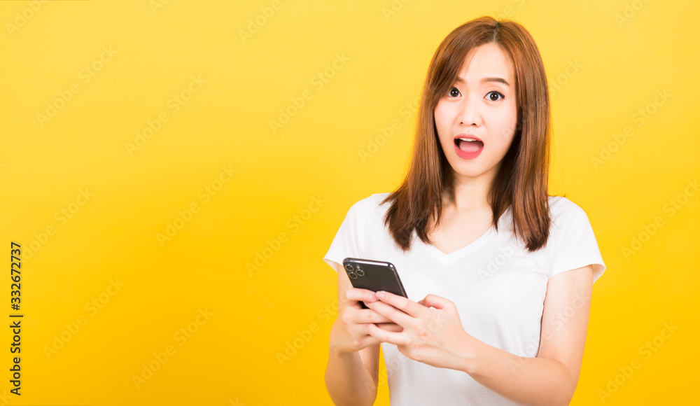 woman teen smiling standing wear t-shirt her surprised excited with smart mobile phone woman teen smiling standing wear t-shirt her surprised excited with smart mobile phone