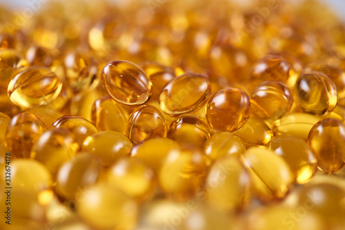 Closeup of a pile of vitamin D yellow pills (frog eye view)