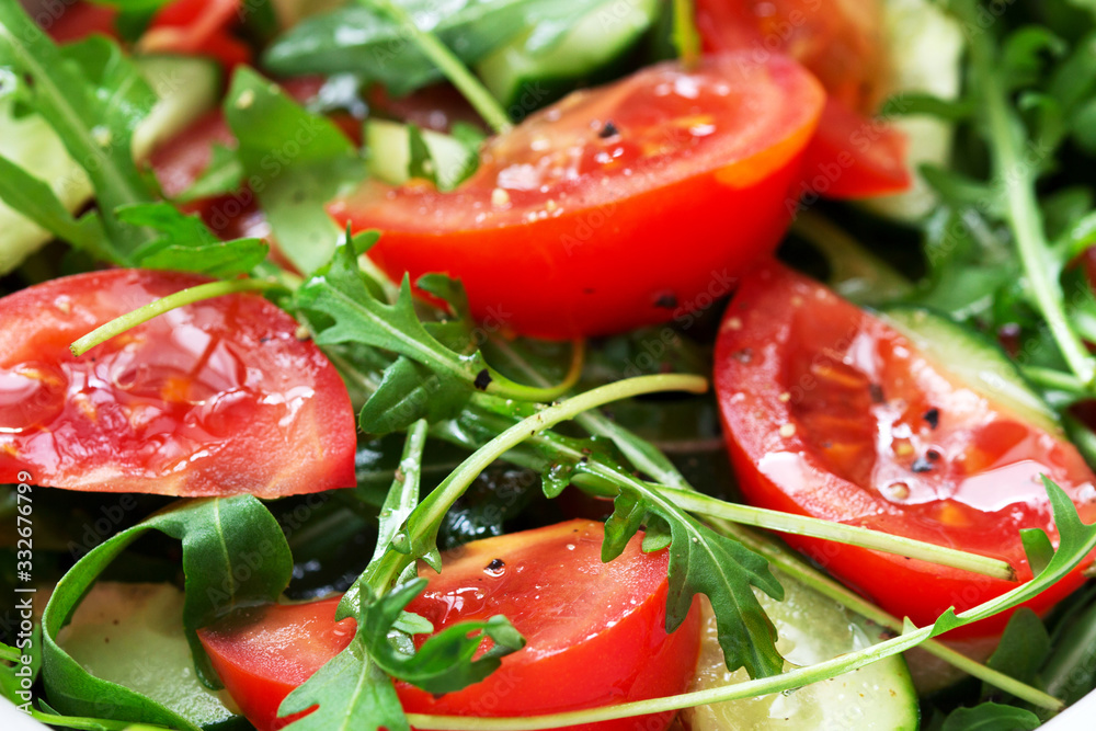 Salad with arugula, tomatoes, cucumbers and lemon sauce. Salad with arugula, tomatoes, cucumbers and lemon sauce.