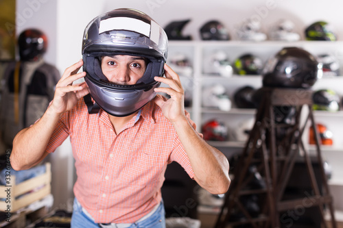 Glad man is trying up new helmet for motorbike