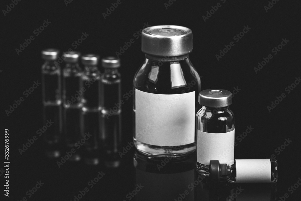 Different types of glass vial medical close-up isolated on a black