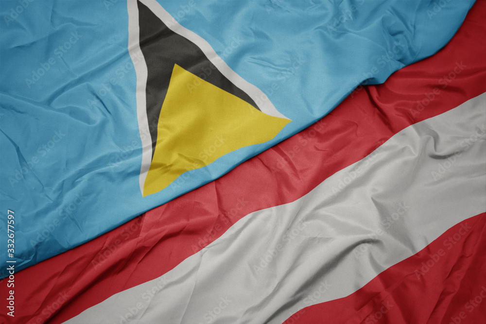 waving colorful flag of austria and national flag of saint lucia. waving colorful flag of austria and national flag of saint lucia.