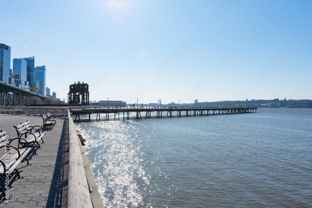 Waterfront and Pier I along the Hudson River in Lincoln Square of New York City with a Clear Blue Sky Waterfront and Pier I along the Hudson River in Lincoln Square of New York City with a Clear Blue Sky