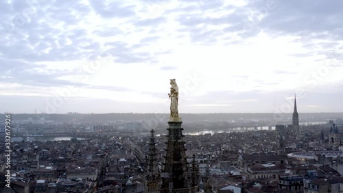 Pey Berland bell tower with madonna and child golden statue Bordeaux Cathedral France, Aerial pedestal tilt down shot
 photo