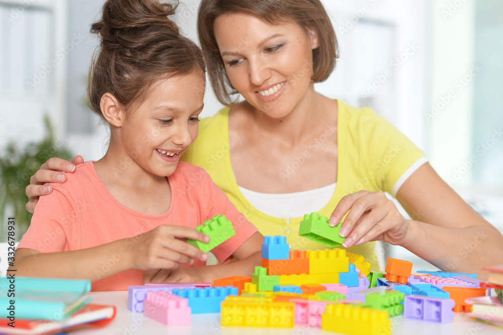 Close up portrait of little girl and her mother playing Close up portrait of little girl and her mother playing
