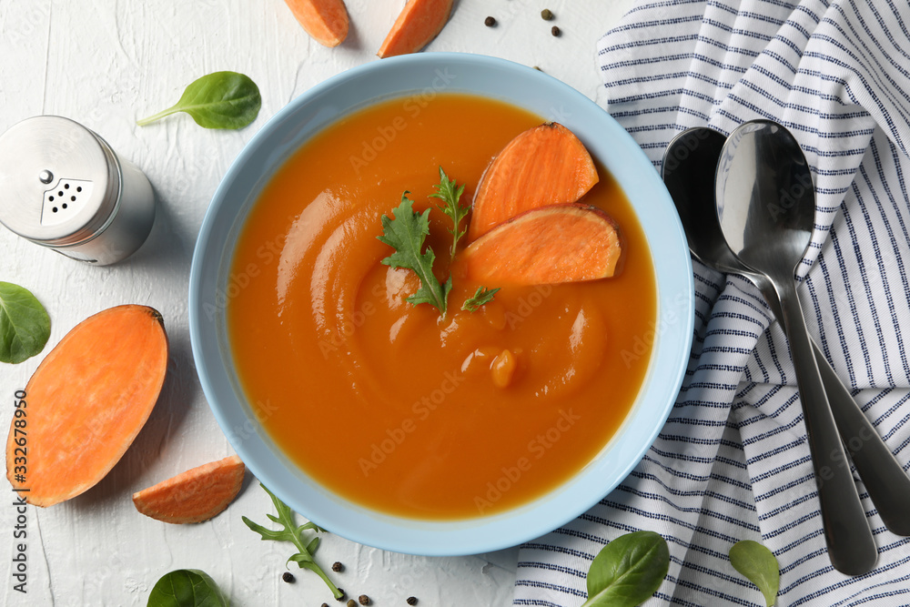 Sweet potato cream soup on white background, top view Sweet potato cream soup on white background, top view
