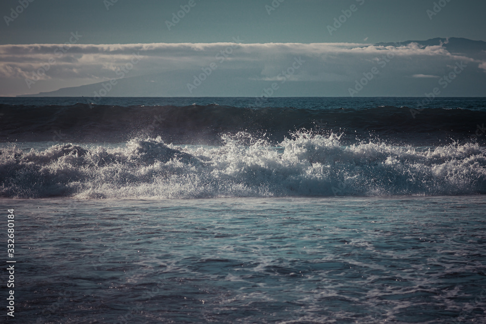 Waves crashing in the sea or ocean in the evening twilight