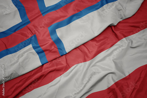 waving colorful flag of austria and national flag of faroe islands.