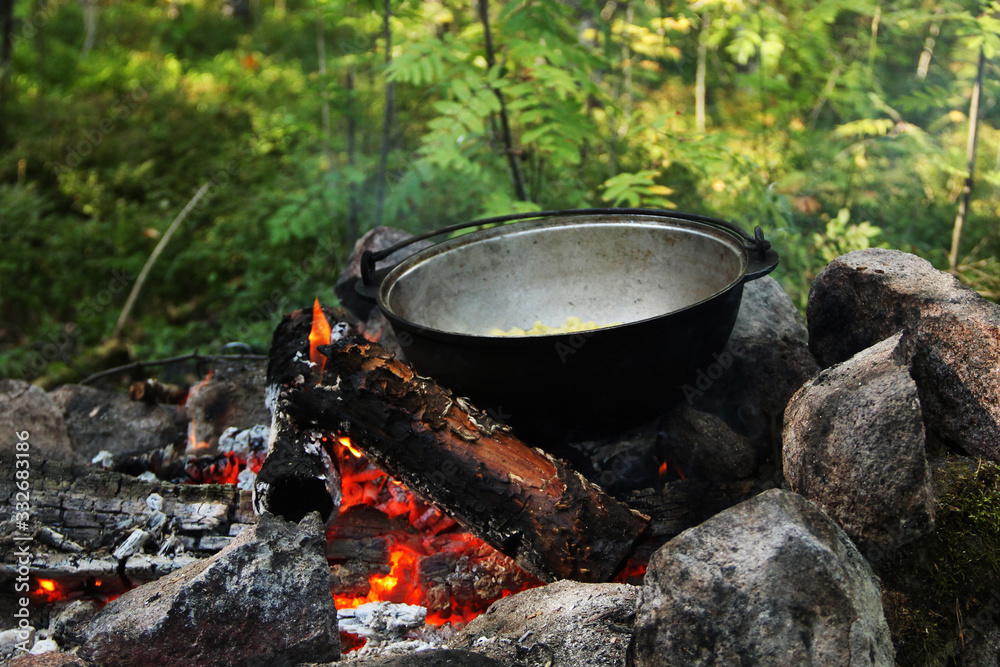 tourist bowler with food on the campfire tourist bowler with food on the campfire