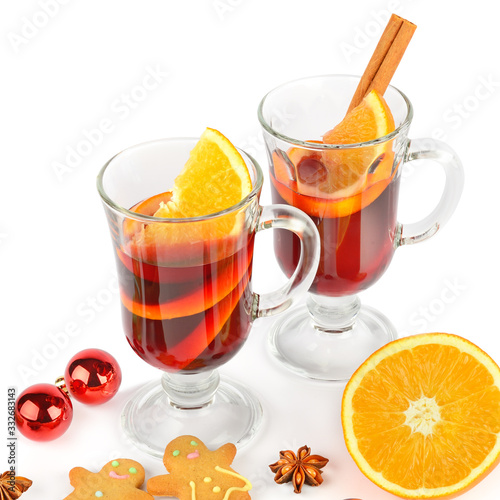 Mulled wine, orange, spices and gingerbread cookies isolated on a white background.