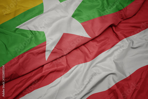 waving colorful flag of austria and national flag of myanmar.