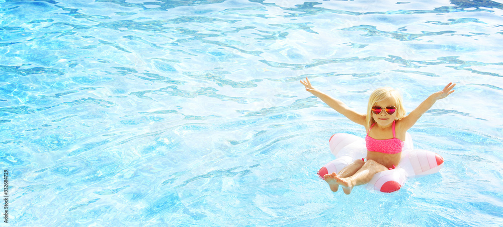 Happy little girl at the swimming pool. Summer vacation. Travel