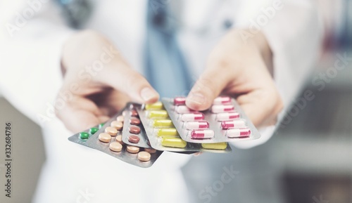 Hands with colorful pills and tablets in hand