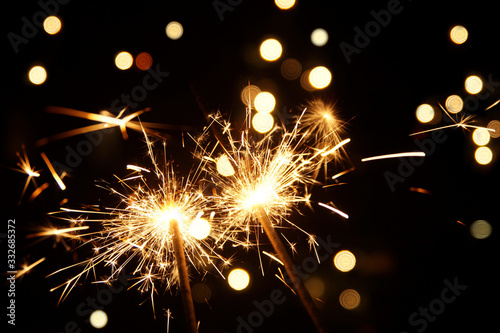 burning sparkler firework. Happy new year and Merry christmas concept. Happy holidays. Abstract blurred of Sparklers for celebration. Magic light. Winter Xmas decoration. Realistic light effect.