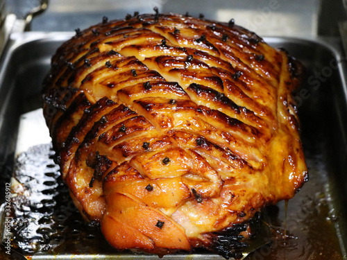 Fotografija honey glazed gammon ham with traditional herbs and spicesin a roasting tray,Cook