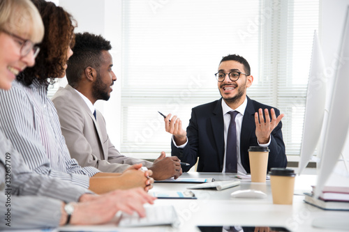 Multy-ethnic group of young business people working with computer at office