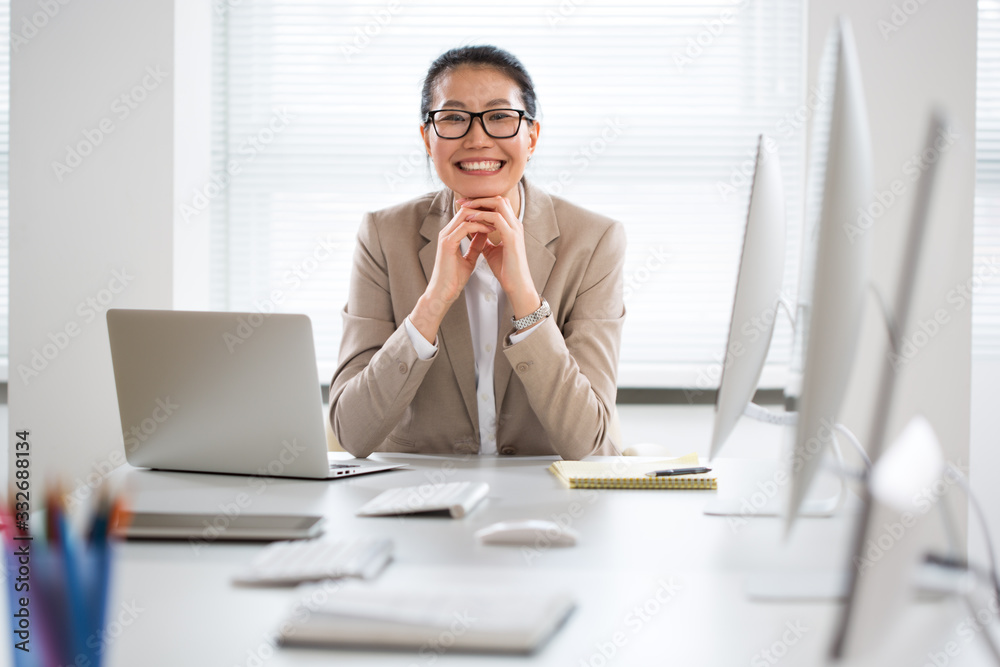 Portrait of asian business woman looking at camera at workplace in an office Portrait of asian business woman looking at camera at workplace in an office