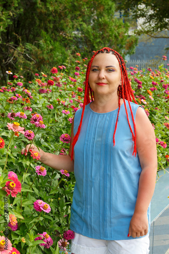 Young woman with red hair posing in red orange colors. photo