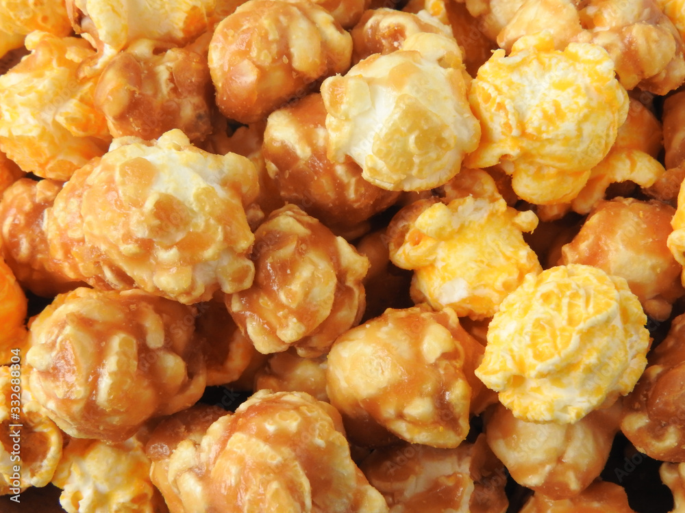Top view of delicious popcorn full of frame. Include buttery caramel corn and rich cheddar cheese corn. Popcorn background. Food and snack concept. Top view of delicious popcorn full of frame. Include buttery caramel corn and rich cheddar cheese corn. Popcorn background. Food and snack concept.