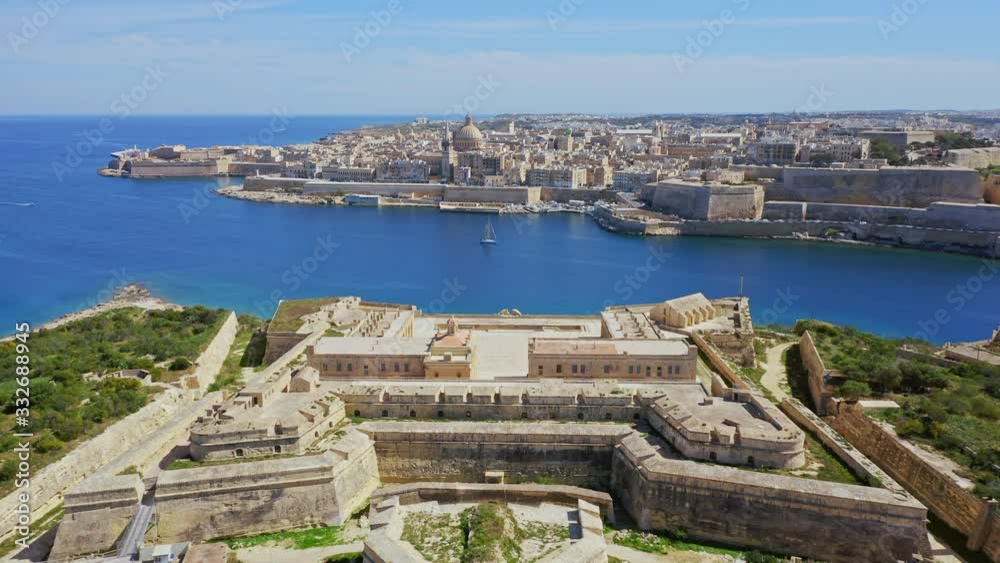 Aerial view of Fort Manoel and Valletta - capital of Malta. Drone flights forward. Mediterranean see, green nature Aerial view of Fort Manoel and Valletta - capital of Malta. Drone flights forward. Mediterranean see, green nature