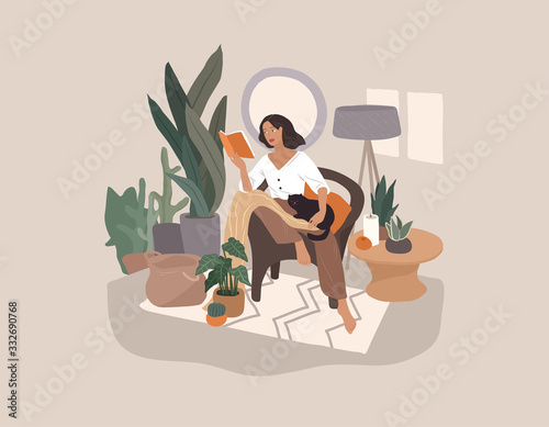 Sweet girl reading a book and resting with a cat and coffee. Feminine Daily life and everyday routine scene by young woman in home interior