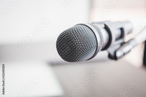 Closeup of microphone in lecture room background speech in seminar convention hall room. Mic speaker of teacher on podium in college or university. Workshop event and Entertainment broadcast concept. © Shutter2U
