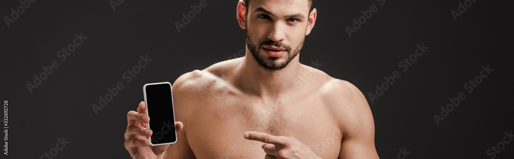 panoramic shot of sexy nude man pointing at smartphone with blank screen isolated on black panoramic shot of sexy nude man pointing at smartphone with blank screen isolated on black