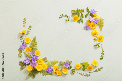 spring yellow and violet  flowers on paper background