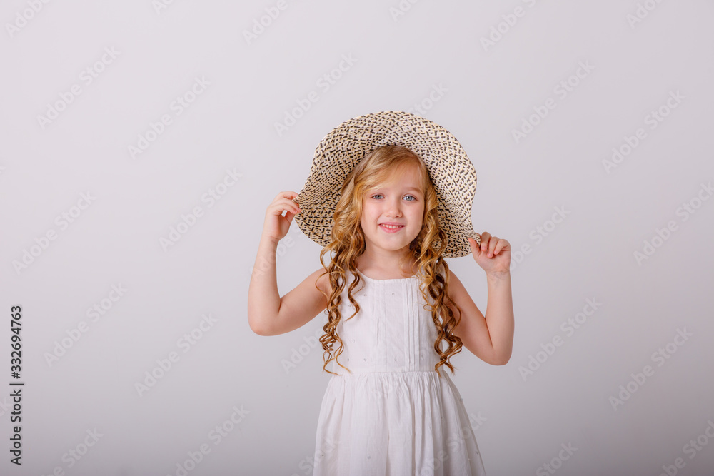 portrait of a little blonde girl in a straw hat on a white background portrait of a little blonde girl in a straw hat on a white background