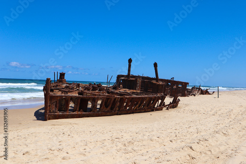 Old wrecked ship on the sand by the water