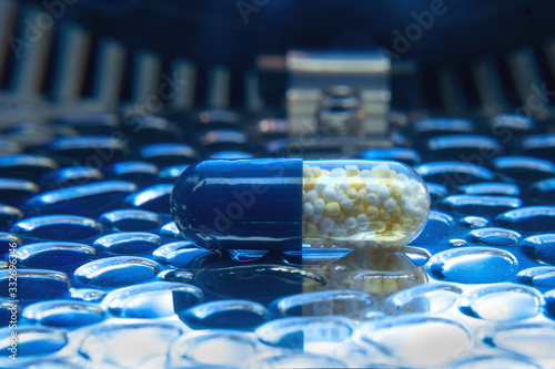 Color medicine pills on blue laboratory table